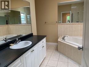 Richmond apartment for rent - A bathroom with a sink, mirror, and bathtub.