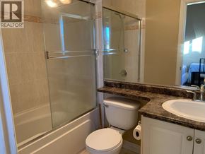 Richmond apartment for rent - A bathroom with a toilet, sink, and shower.