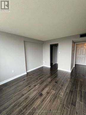 London North (North G) condo for rent - A room with wooden flooring and white walls.
