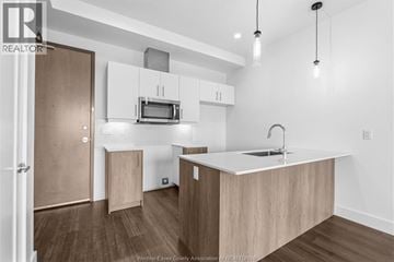Windsor condo for rent - A kitchen with a microwave above the stove and a sink on the counter.