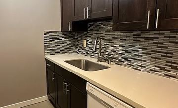 Seattle apartment for rent - A kitchen with a sink and a backsplash.