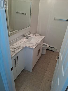 Sudbury apartment for rent - A bathroom with a marble counter top and white cabinets.
