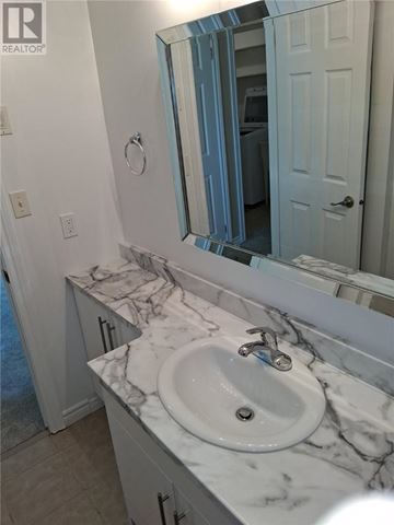 Sudbury apartment for rent - A bathroom with a marble countertop and a white sink.