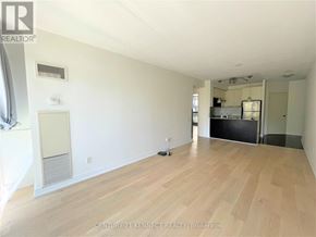 Toronto (Church-Yonge Corridor) condo for rent - A spacious room with wooden flooring and white walls.