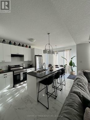 London North (North I) townhouse for rent - A modern kitchen with white cabinets and black countertops.