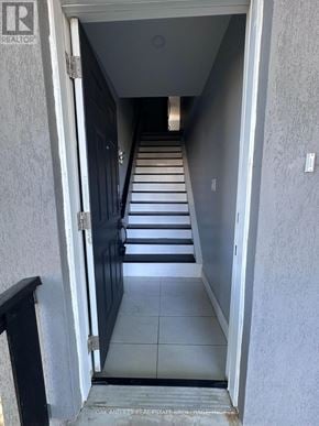 Toronto (Rockcliffe-Smythe) duplex for rent - A hallway with a black door and a sign that says "REALTOR".