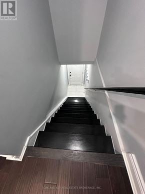 Toronto (Rockcliffe-Smythe) duplex for rent - A long flight of stairs with a white wall on the side and a wooden floor.