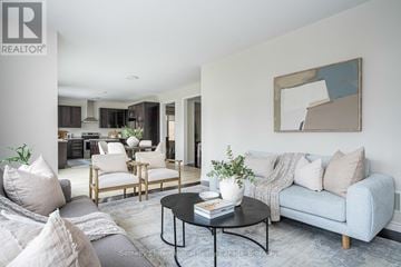 Collingwood apartment for rent - A living room with a grey couch, a coffee table, and a painting on the wall.