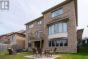 Collingwood apartment for rent - A large brick house with a patio and chairs.