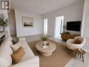 Hamilton (Corktown) condo for rent - A living room with a beige sofa, a coffee table, and a television.