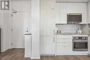 Oakville (Ro River Oaks) condo for rent - A kitchen with white cabinets and a microwave above the stove.