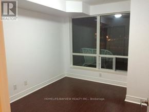 Markham (Commerce Valley) condo for rent - A room with a window and a wooden floor.