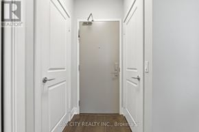 Markham (Unionville) condo for rent - A hallway with white doors and a sign that says Big City Realty.