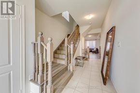 Hamilton (Waterdown) apartment for rent - A hallway with a staircase and a mirror on the wall.