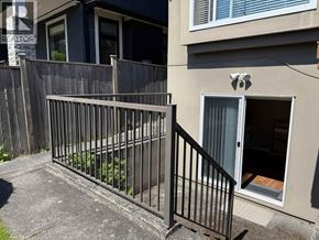 Vancouver apartment for rent - A black metal fence in front of a house.