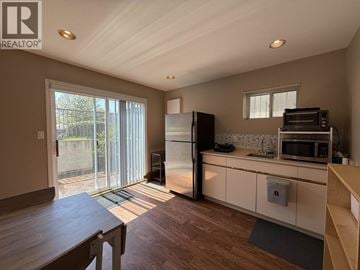 Vancouver apartment for rent - A kitchen with a refrigerator, microwave, and oven.