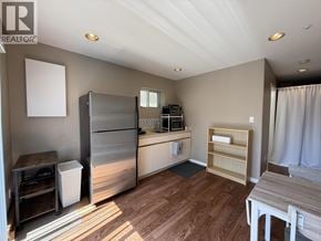 Vancouver apartment for rent - A kitchen with a refrigerator, oven, and microwave.