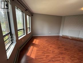 Vancouver apartment for rent - A room with wooden flooring and a brick wall.