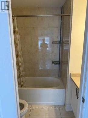 Markham (Cornell) apartment for rent - A white bathroom with a toilet, tub, and shower.