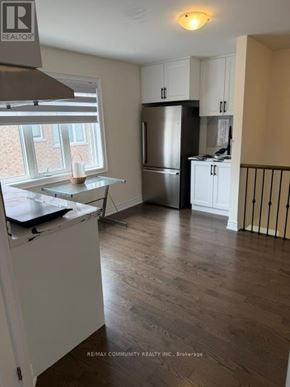 Markham (Cornell) apartment for rent - A kitchen with a refrigerator, cabinets, and a window.