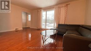 Richmond Hill (Crosby) apartment for rent - A living room with a couch, coffee table, and sliding glass door.