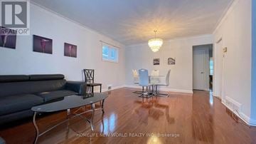 Richmond Hill (Crosby) apartment for rent - A living room with a black leather couch and a wooden floor.