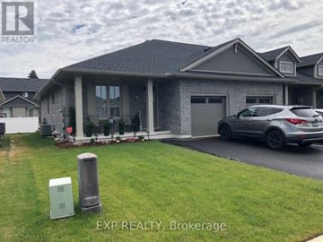 Tillsonburg townhouse for rent - A house with a grey roof and a grey car parked in front.