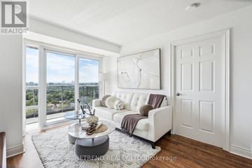 Toronto (Newtonbrook West) condo for rent - A living room with a white couch and a coffee table.