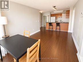 Toronto (Bendale) condo for rent - A black table and chairs in a room with wooden floors.