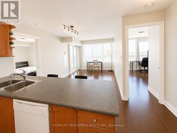Toronto (Bendale) condo for rent - A kitchen with a sink and a dining table with chairs.