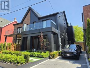 Toronto (Trinity-Bellwoods) apartment for rent - A black car is parked in front of a modern house.