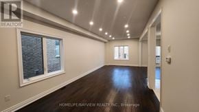 Innisfil (Lefroy) apartment for rent - A spacious room with wooden floors and a large window.