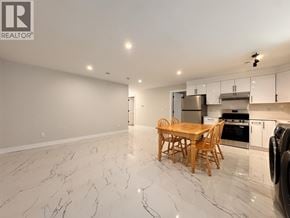 Burnaby apartment for rent - A kitchen with a table and chairs in the middle of the room.
