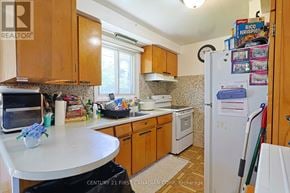 London South (South J) apartment for rent - A kitchen with wooden cabinets and a white refrigerator.