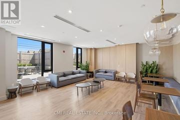 Milton (Fo Ford) condo for rent - A spacious living room with a grey sofa set and a wooden floor.