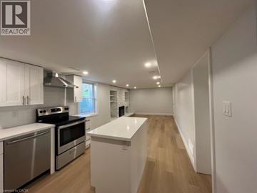 Kitchener apartment for rent - A kitchen with white cabinets and a white island.