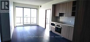 Toronto (Bayview Village) condo for rent - A realtor's sign is in the corner of a well-lit, empty living space.