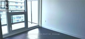 Toronto (Bayview Village) condo for rent - A room with a large window and a view of a building across the street.