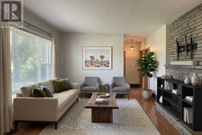 Caledon (Caledon East) apartment for rent - A living room with a couch, chairs, and a fireplace.