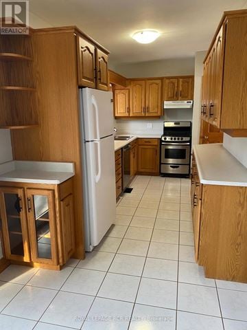 Caledon (Caledon East) apartment for rent - A kitchen with wooden cabinets and a white refrigerator.