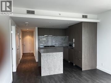 North Vancouver apartment for rent - A modern kitchen with a marble island in the middle.