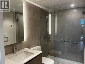 North Vancouver apartment for rent - A bathroom with a marble wall and a glass shower stall.