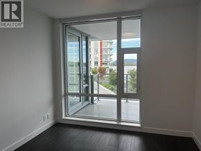 North Vancouver apartment for rent - A room with a large window and a view of a building outside.
