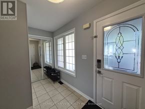 Milton (Be Beaty) apartment for rent - A hallway with a stained glass window and a door.