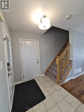 Milton (Be Beaty) apartment for rent - A hallway with a staircase and a door.