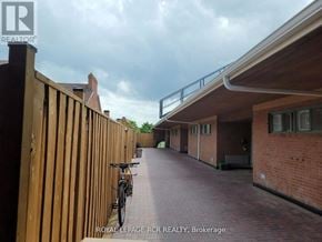 Aurora (Hills Of St Andrew) multi-family for rent - A bicycle is parked on a brick pathway.