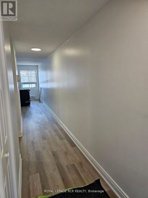 Aurora (Hills Of St Andrew) multi-family for rent - A long hallway with wood floors and white walls.