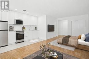 Toronto (Rosedale-Moore Park) condo for rent - A modern kitchen with white cabinets and stainless steel appliances.