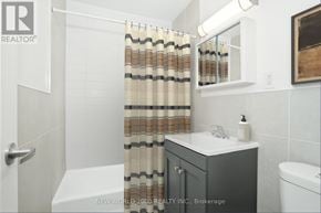Toronto (Rosedale-Moore Park) condo for rent - A bathroom with a white tub, a sink, and a shower curtain.