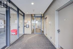 Toronto (Danforth Village-East York) condo for rent - A hallway with a glass door leading to a room with a bed in it.